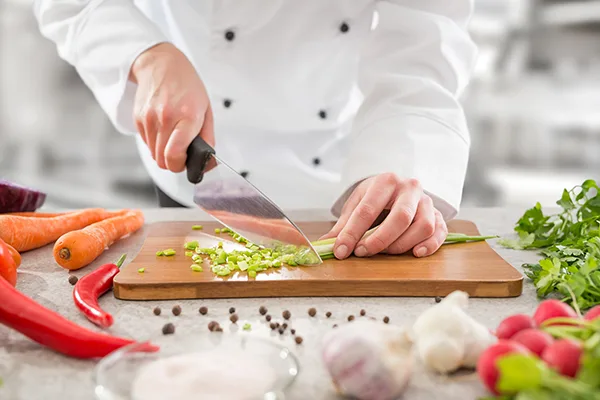 How do you safely use a kitchen knife?